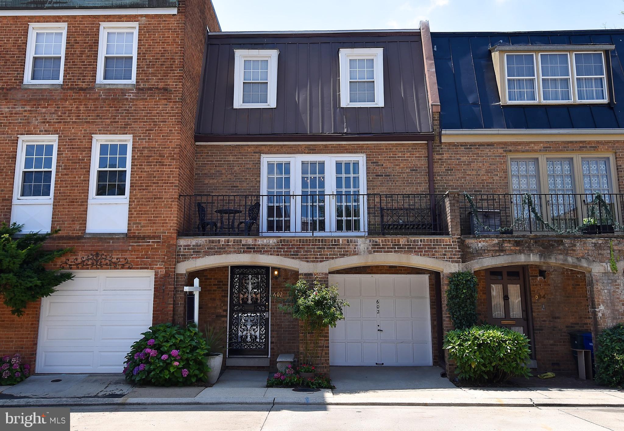 a front view of a building with potted plants