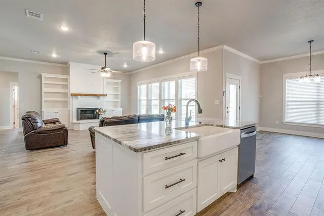 a kitchen with counter top space and living room