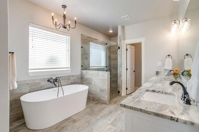 a bathroom with a tub sink and mirror