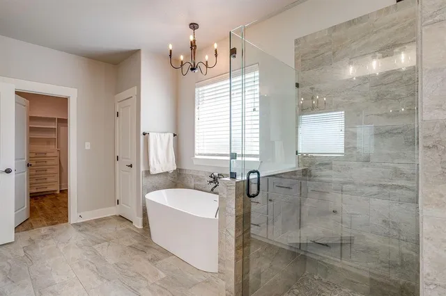 a spacious bathroom with sink shower and mirror