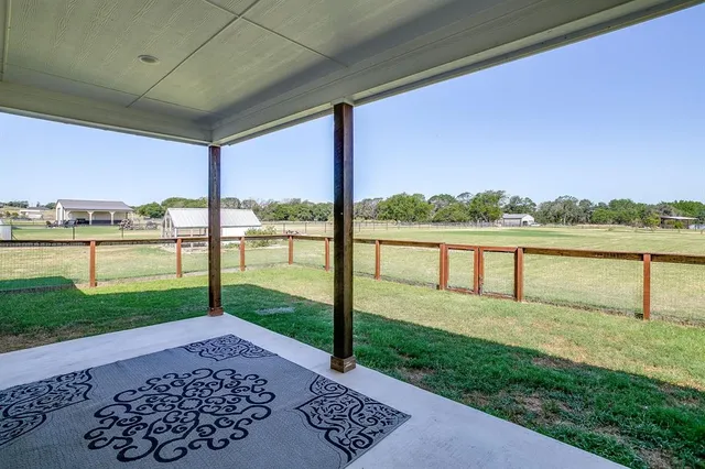 a view of a house with pool and sitting area