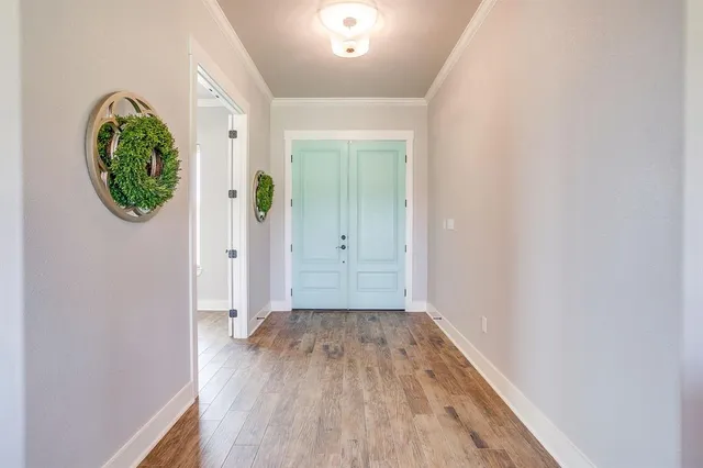 an empty room with wooden floor and a window