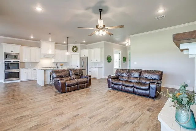 a living room with furniture and kitchen view