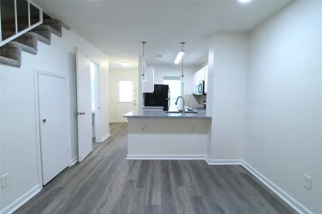 a view of kitchen with wooden floor