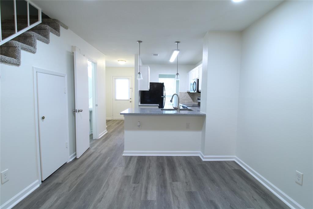 605 Carriagehouse Lane, Unit B2 Garland, TX 75040 - Photo 4 of 11 a view of kitchen with wooden floor