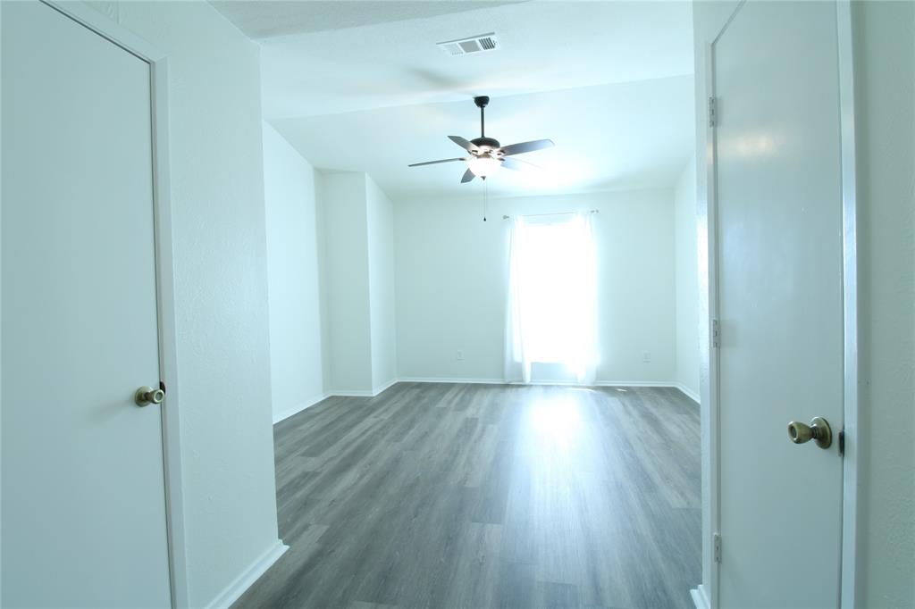 605 Carriagehouse Lane, Unit B2 Garland, TX 75040 - Photo 7 of 11 a view of an empty room with wooden floor