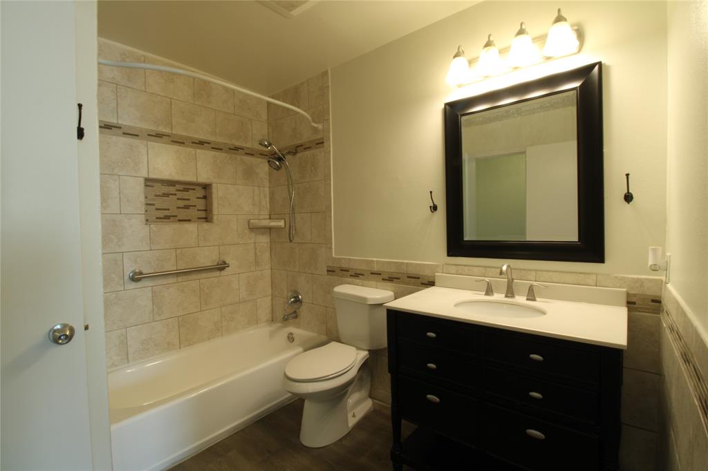 605 Carriagehouse Lane, Unit B2 Garland, TX 75040 - Photo 8 of 11 a bathroom with a sink vanity mirror bathtub and toilet