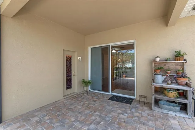 a view of an empty room and bedroom with furniture and windows