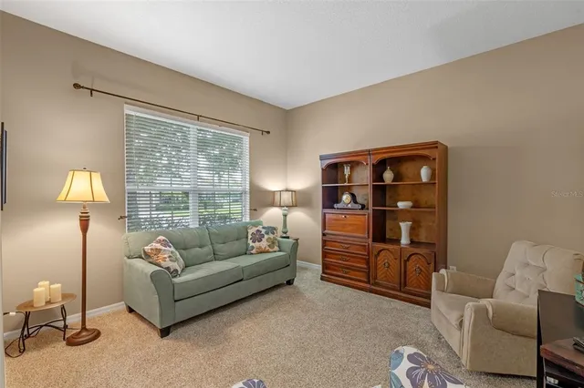 a living room with furniture and a lamp