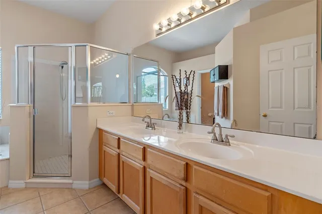 a bathroom with a double vanity sink mirror and