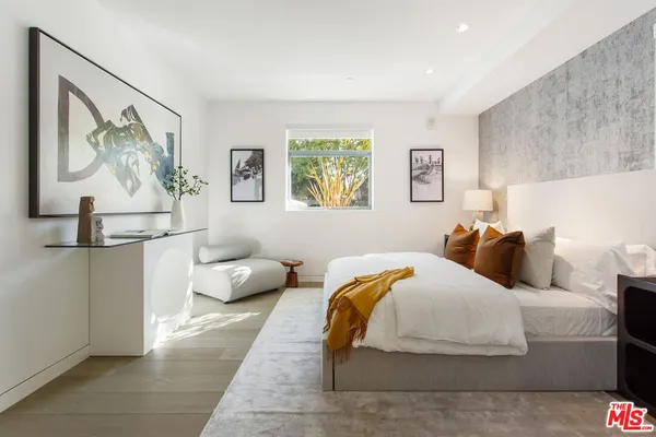 a bed room with a bed and a lamp