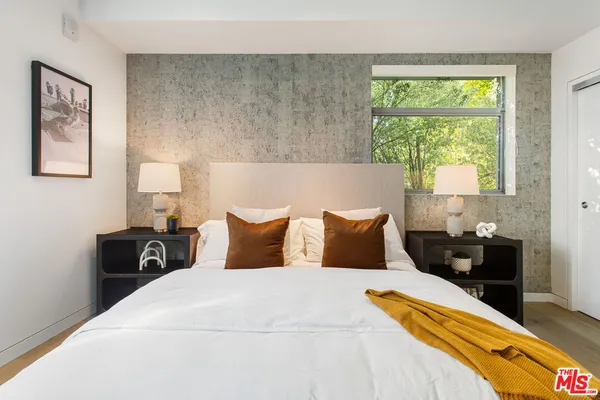 a bedroom with a bed and a mirror