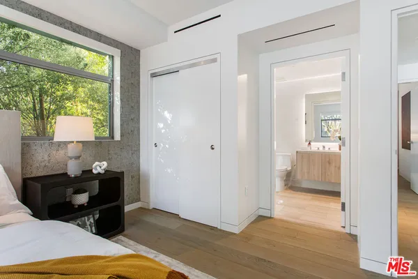 a bathroom with a sink mirror vanity and toilet