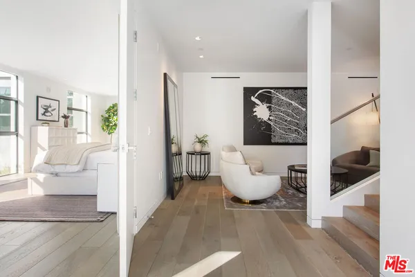 a view of living room with furniture and a floor to ceiling window