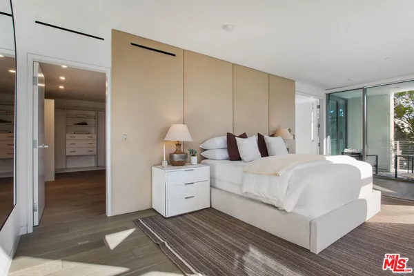 a bathroom with a granite countertop sink a large mirror a toilet and a shower