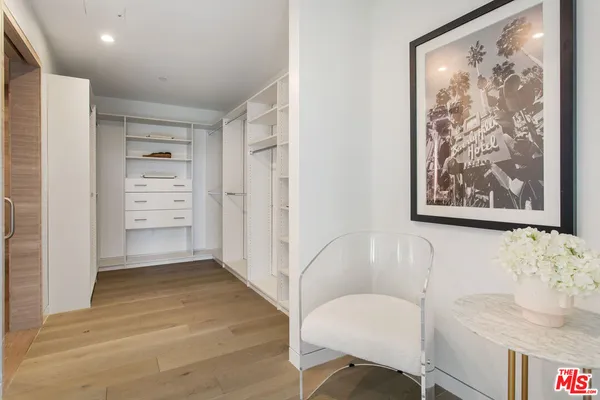 a view of a room with wooden floor and cabinet
