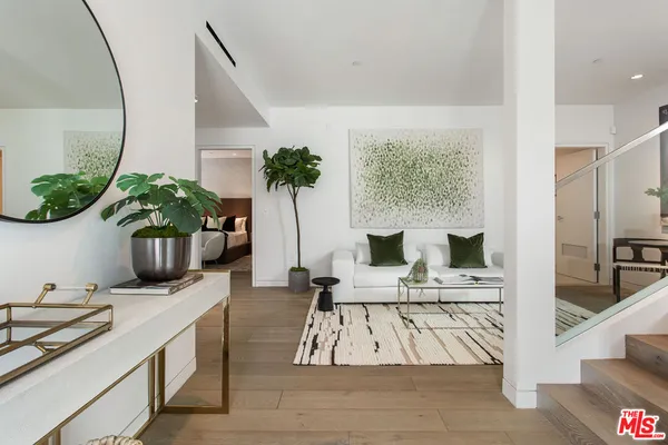 a living room with furniture and a potted plant