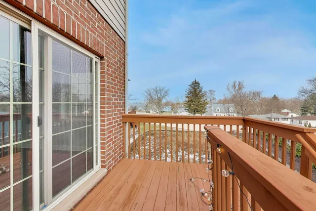 a view of a balcony with wooden floor and fence