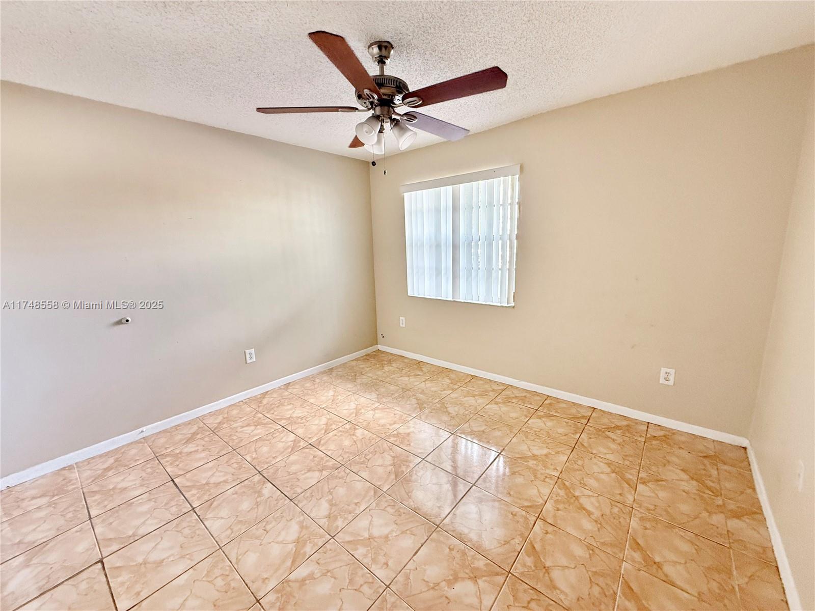 Tamiami Miami, FL 33184 - Photo 14 of 27 a view of a livingroom with a ceiling fan and window