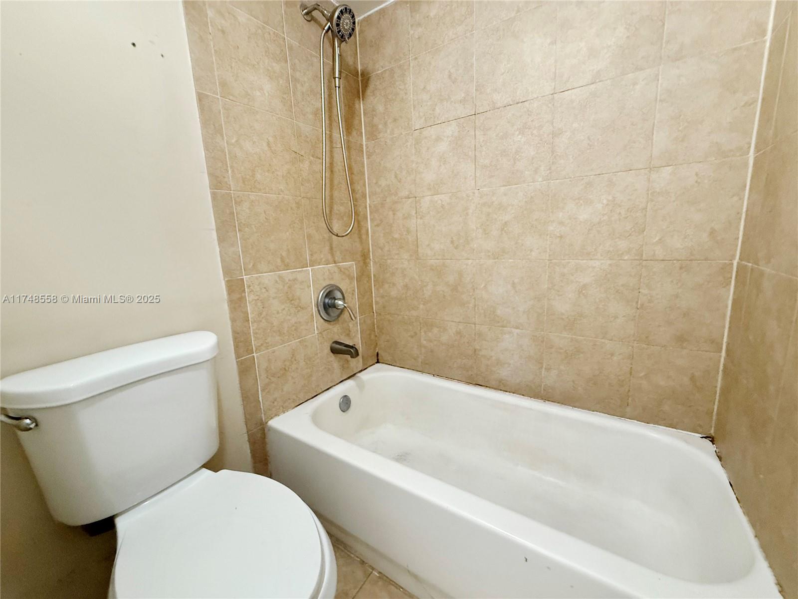 Tamiami Miami, FL 33184 - Photo 16 of 27 a white bath tub sitting next to a white toilet