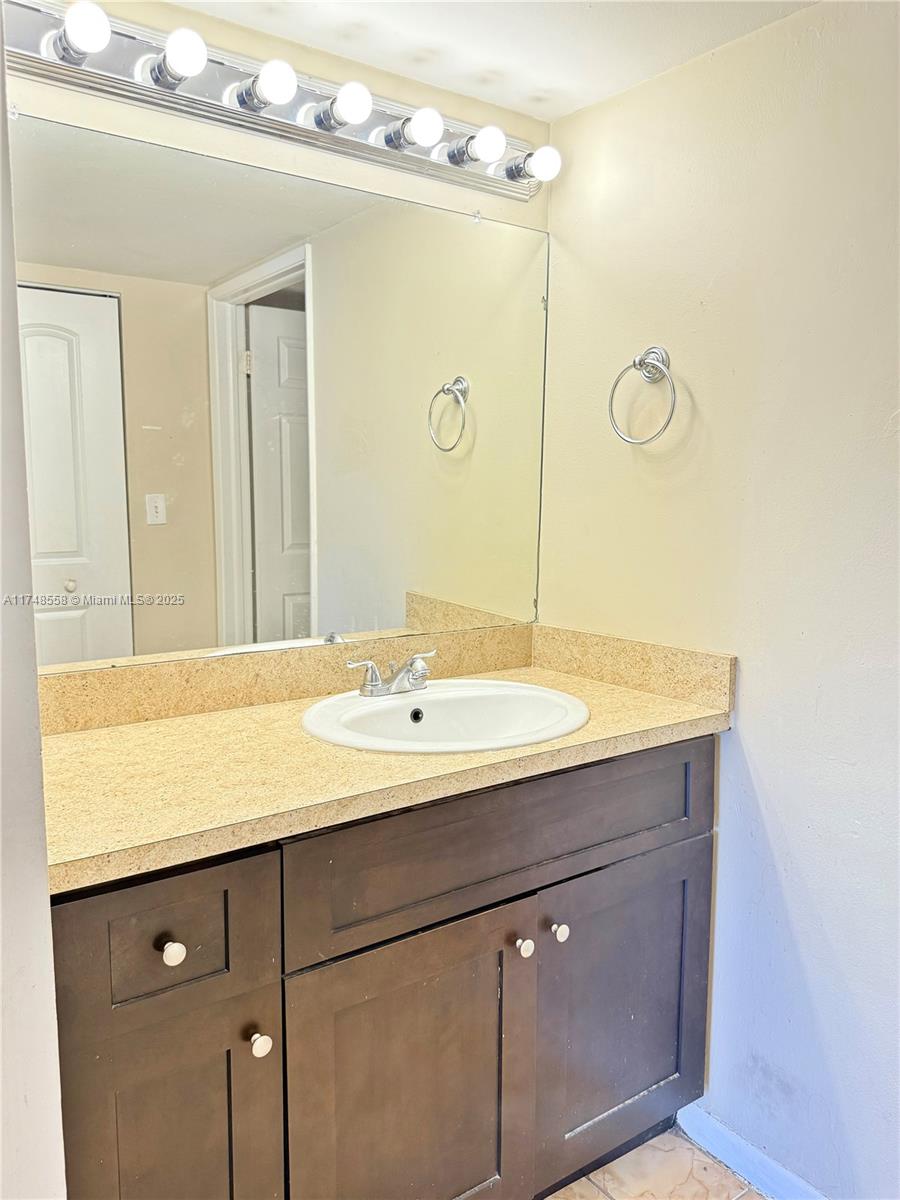 Tamiami Miami, FL 33184 - Photo 26 of 27 a bathroom with a sink vanity granite and a mirror