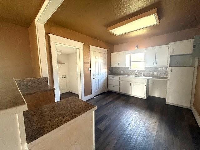 700 West 8th Street Cisco, TX 76437 - Photo 3 of 13 a kitchen with refrigerator and white cabinets