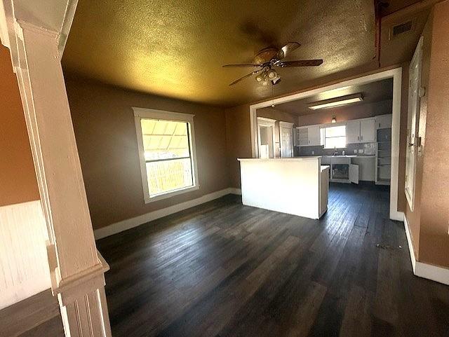 700 West 8th Street Cisco, TX 76437 - Photo 4 of 13 a view of a livingroom with furniture wooden floor and a kitchen