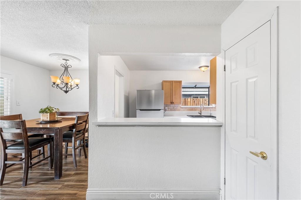 45323 Andale Avenue Lancaster, CA 93535 - Photo 11 of 29 a kitchen with stainless steel appliances granite countertop a table and chairs in it