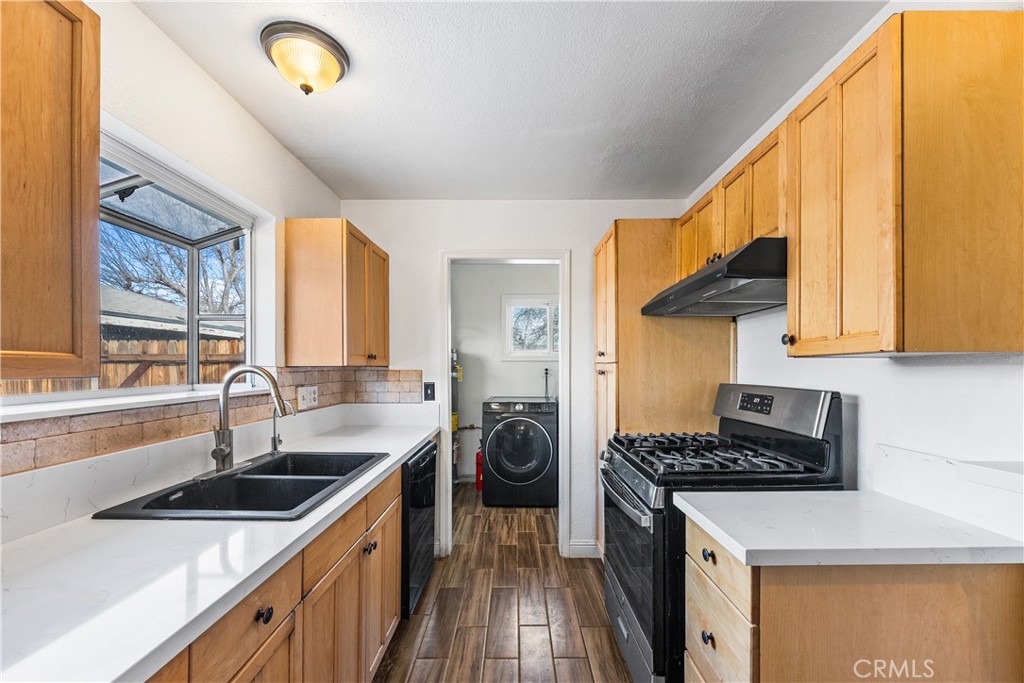 45323 Andale Avenue Lancaster, CA 93535 - Photo 13 of 29 a kitchen with a sink a stove and cabinets