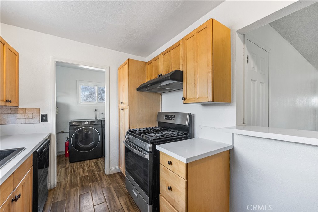 45323 Andale Avenue Lancaster, CA 93535 - Photo 14 of 29 a kitchen with a stove a sink and a refrigerator