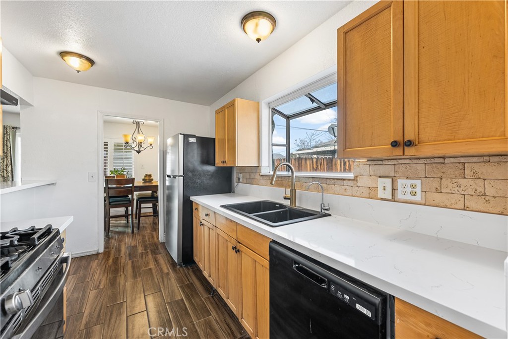 45323 Andale Avenue Lancaster, CA 93535 - Photo 15 of 29 a kitchen that has a sink and a stove