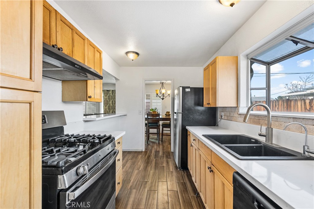 45323 Andale Avenue Lancaster, CA 93535 - Photo 16 of 29 a kitchen that has a sink and a stove