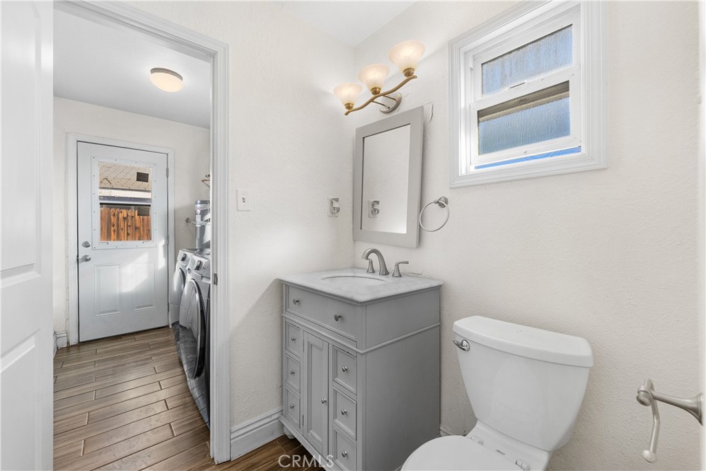 45323 Andale Avenue Lancaster, CA 93535 - Photo 19 of 29 a bathroom with a toilet sink and mirror
