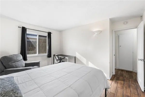 a bedroom with a bed and a large window