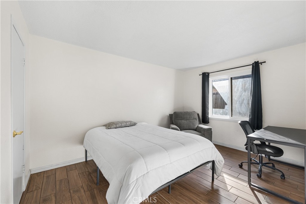 45323 Andale Avenue Lancaster, CA 93535 - Photo 25 of 29 a bedroom with a bed and a table