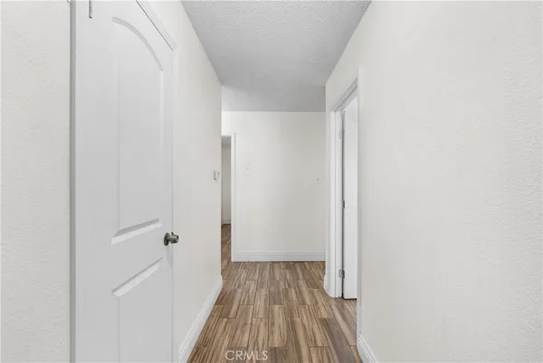 a view of a room with wooden floor