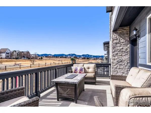 a balcony with wooden floor and city view
