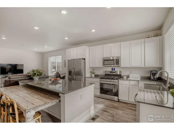 a kitchen with a sink a stove and refrigerator