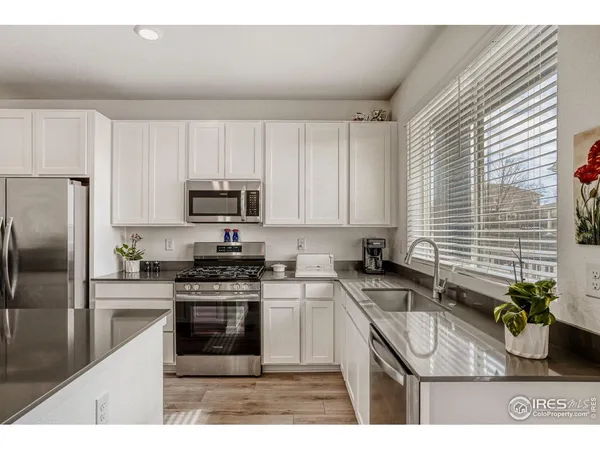 a kitchen with kitchen island granite countertop lots of counter top space and stainless steel appliances
