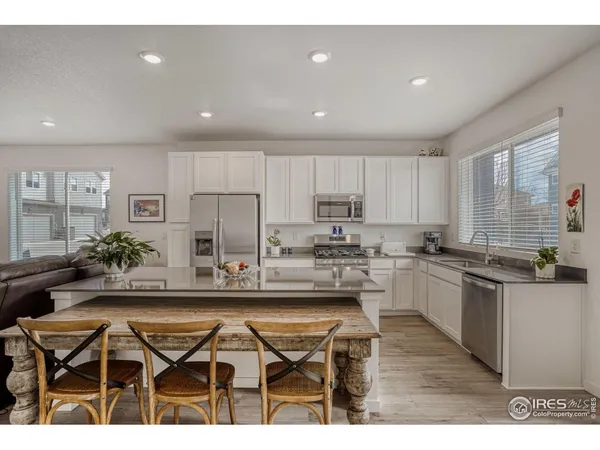 a kitchen with refrigerator and cabinets