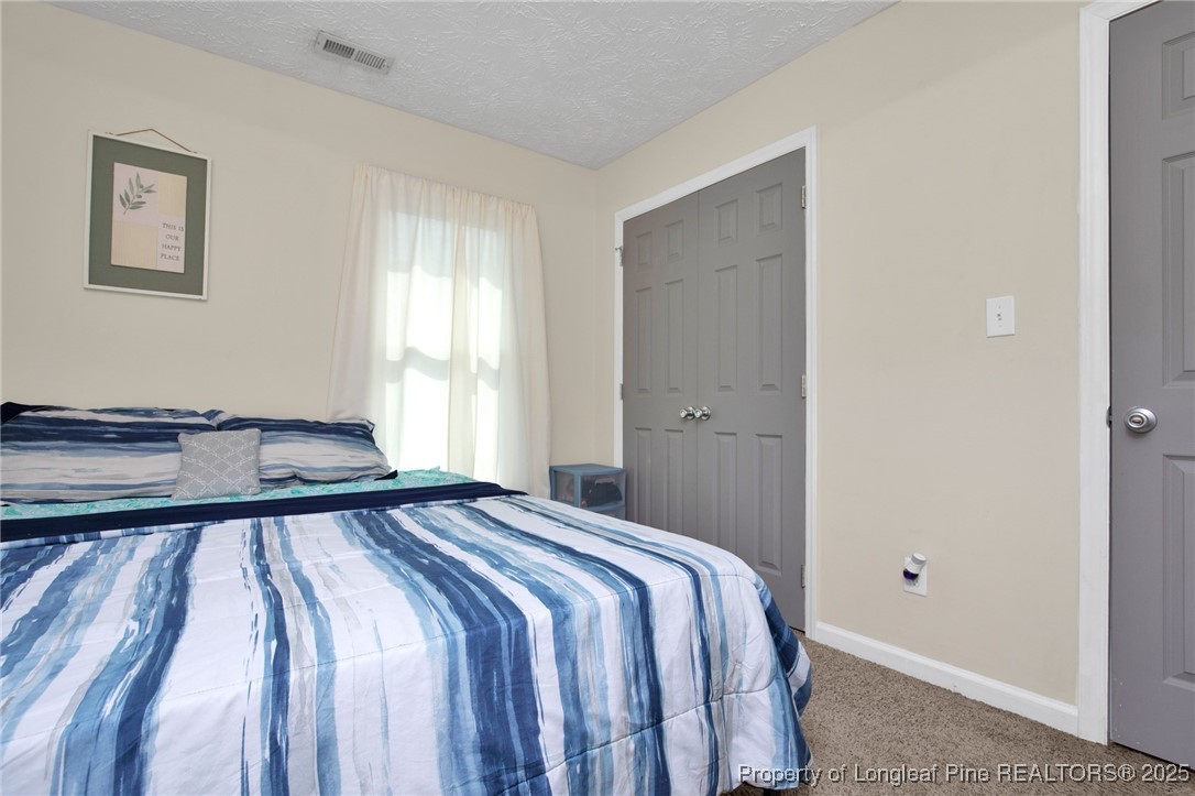 5004 Paulsun Drive Fayetteville, NC 28304 - Photo 21 of 31 a bedroom with a bed and a window