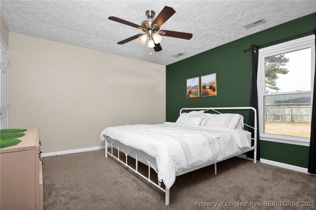 5004 Paulsun Drive Fayetteville, NC 28304 - Photo 22 of 31 a bedroom with a bed and window