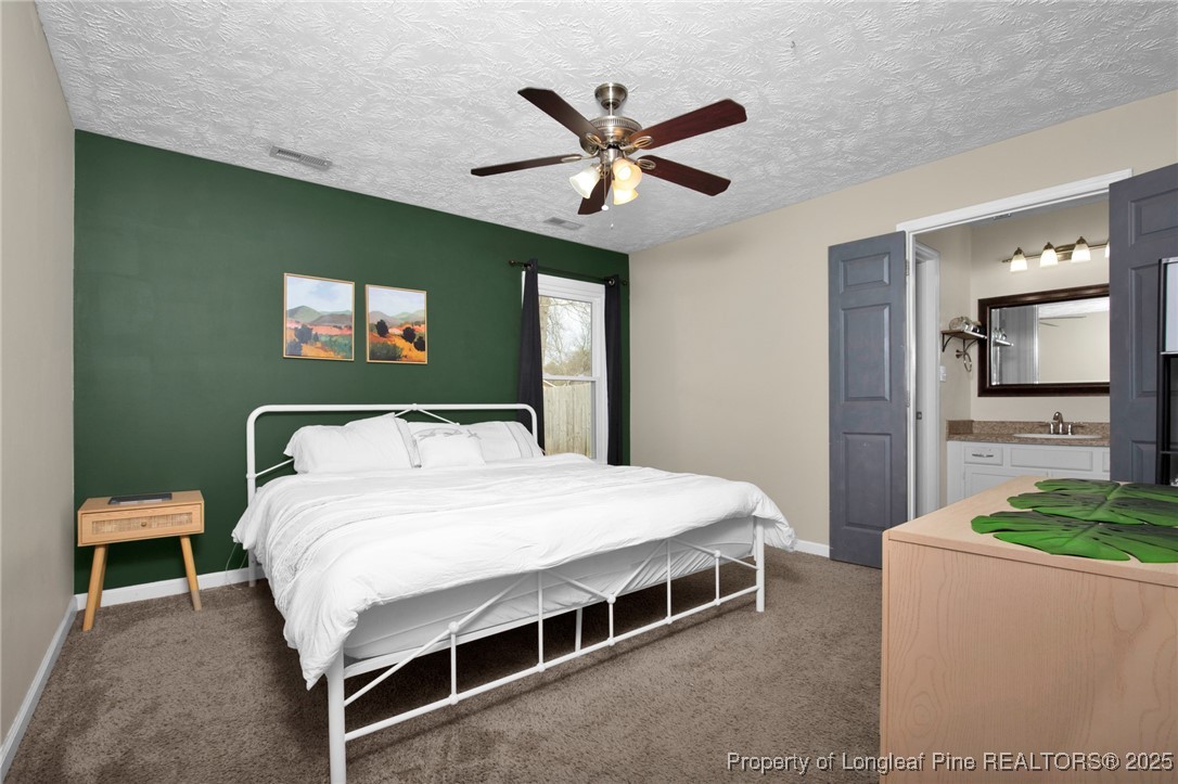 5004 Paulsun Drive Fayetteville, NC 28304 - Photo 23 of 31 a bedroom with a bed and a chandelier