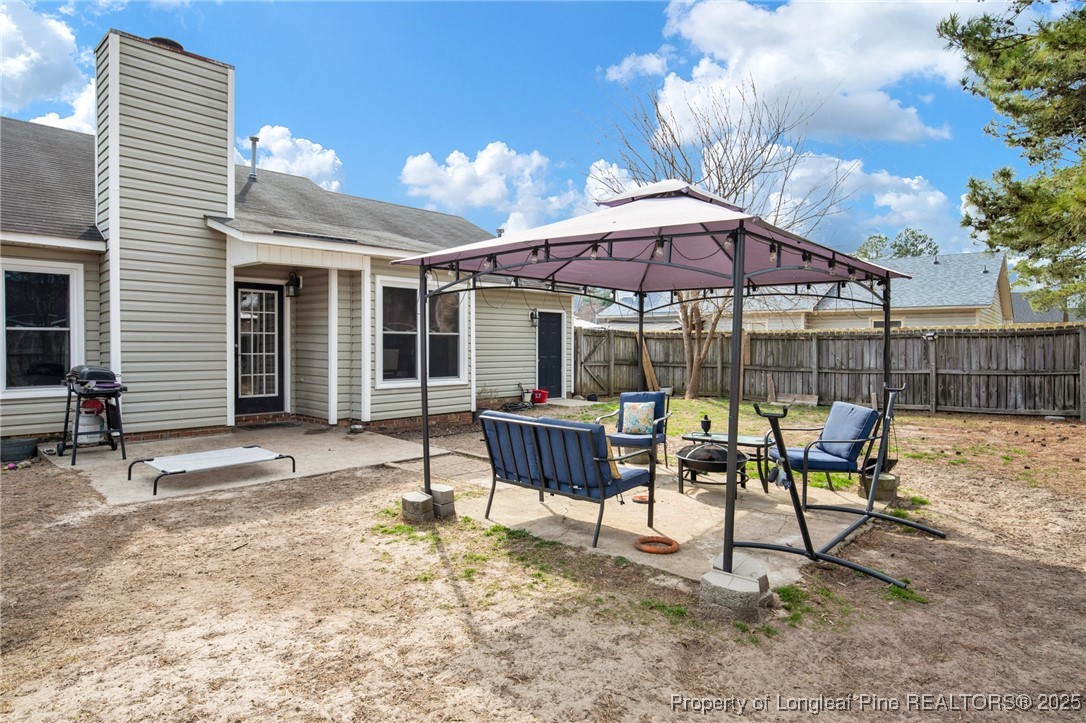 5004 Paulsun Drive Fayetteville, NC 28304 - Photo 27 of 31 a view of a patio with a table and chairs under an umbrella