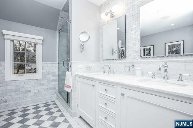 10 Orchard Place Tenafly, NJ 07670 - Photo 15 of 25 a bathroom with a granite countertop sink mirror and a