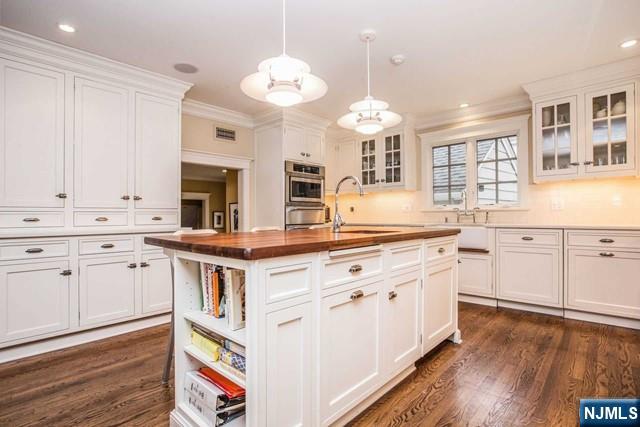 10 Orchard Place Tenafly, NJ 07670 - Photo 3 of 25 a kitchen with granite countertop white cabinets and white appliances
