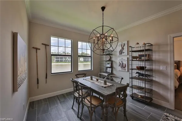 a view of a dining room with a table and chairs