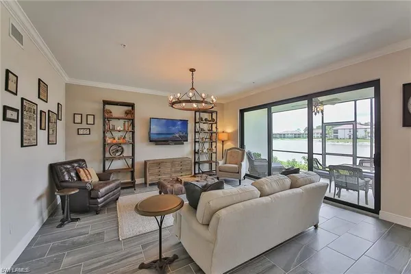 a living room with furniture and a chandelier