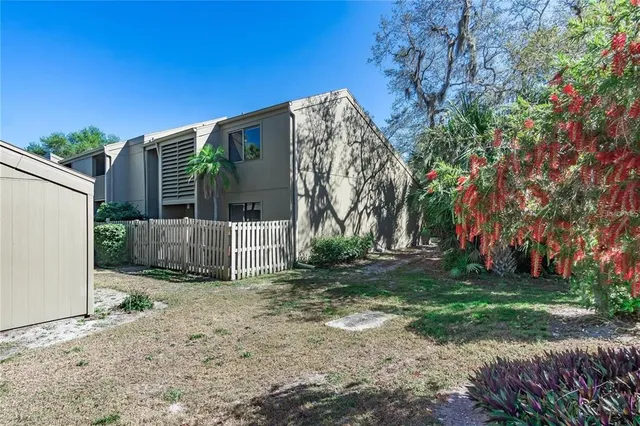 a view of a house with a yard and pathway