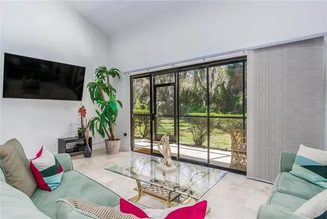 a living room with furniture and a large window with outer view